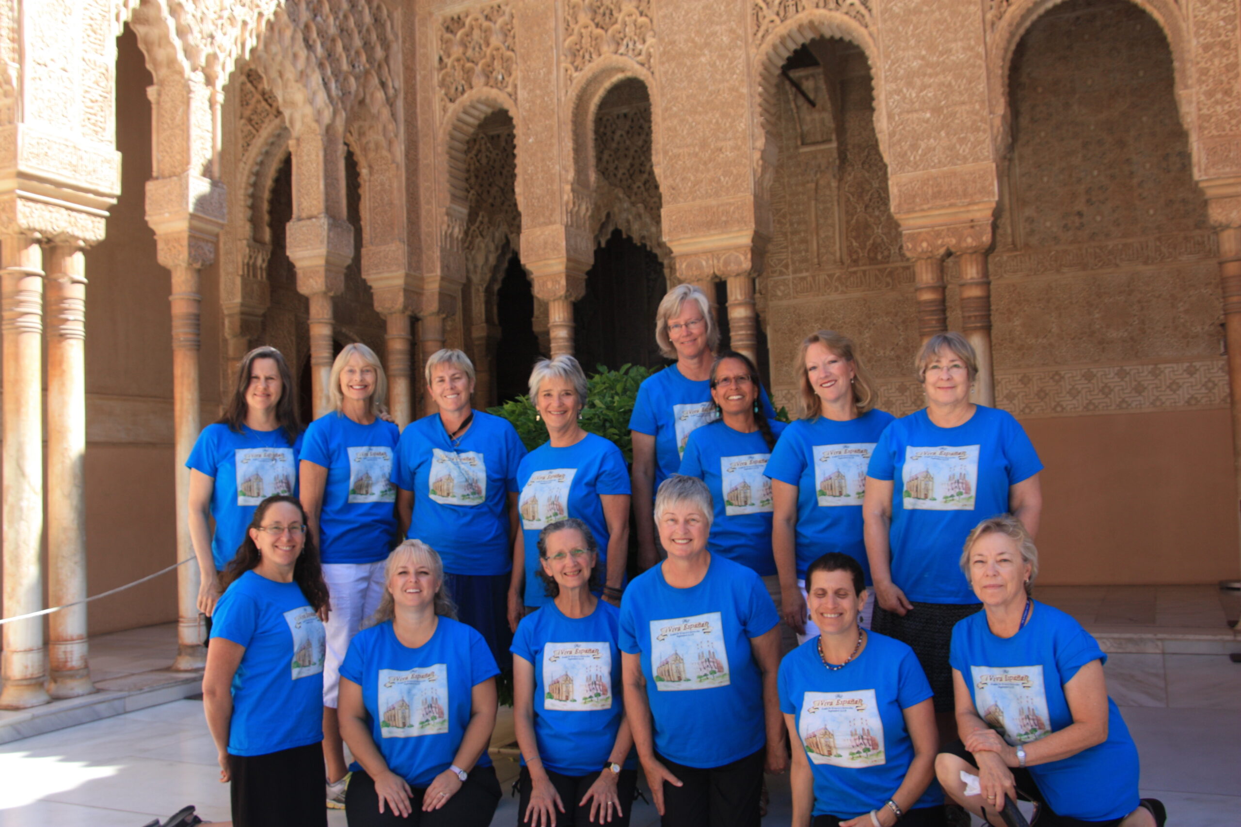 Smiling group of singers, wearing bright blue t-shirts, in Alhambra Spain, 2013