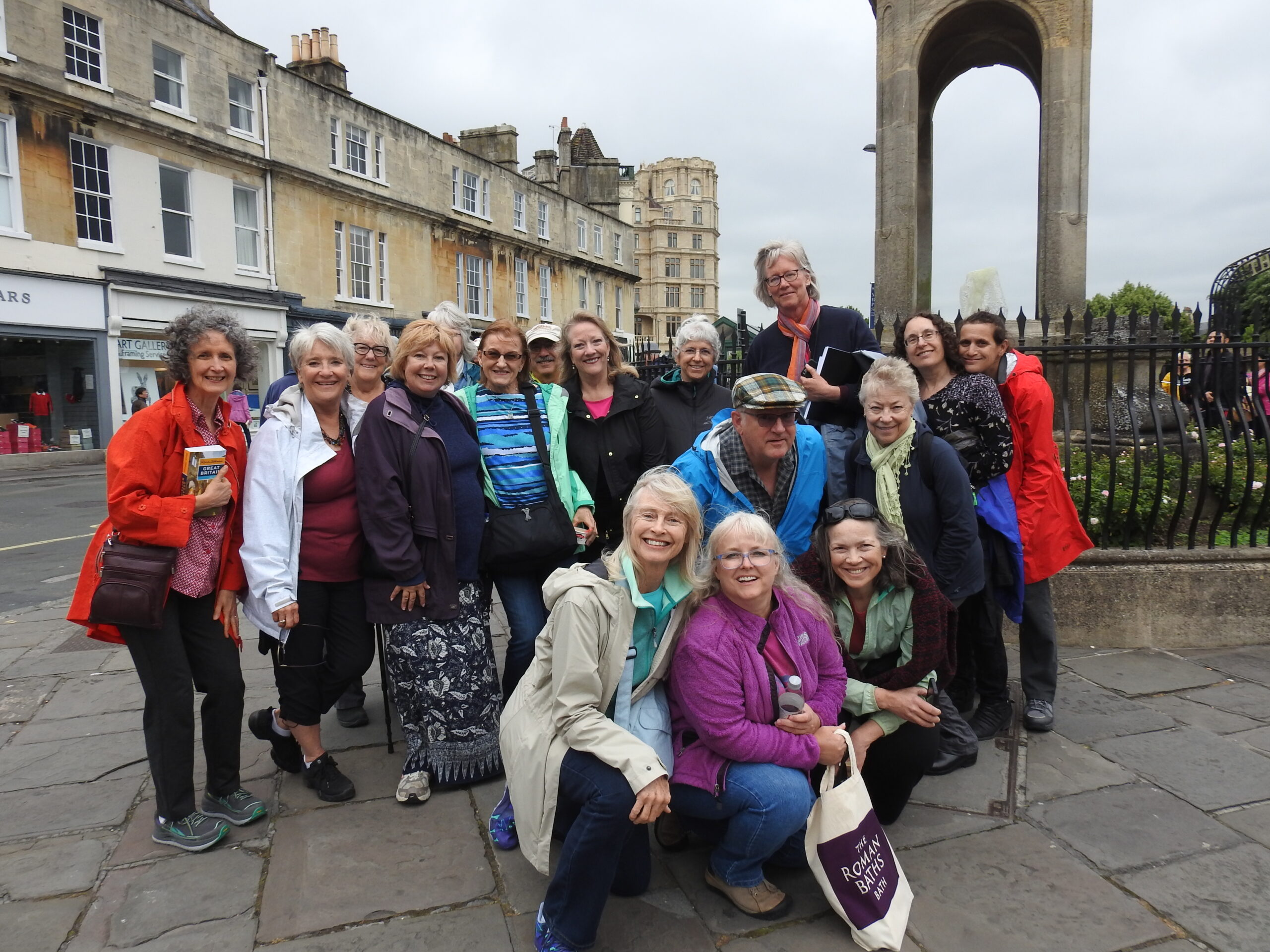 Ensemble touring group in raincoats, Bath England, 2018