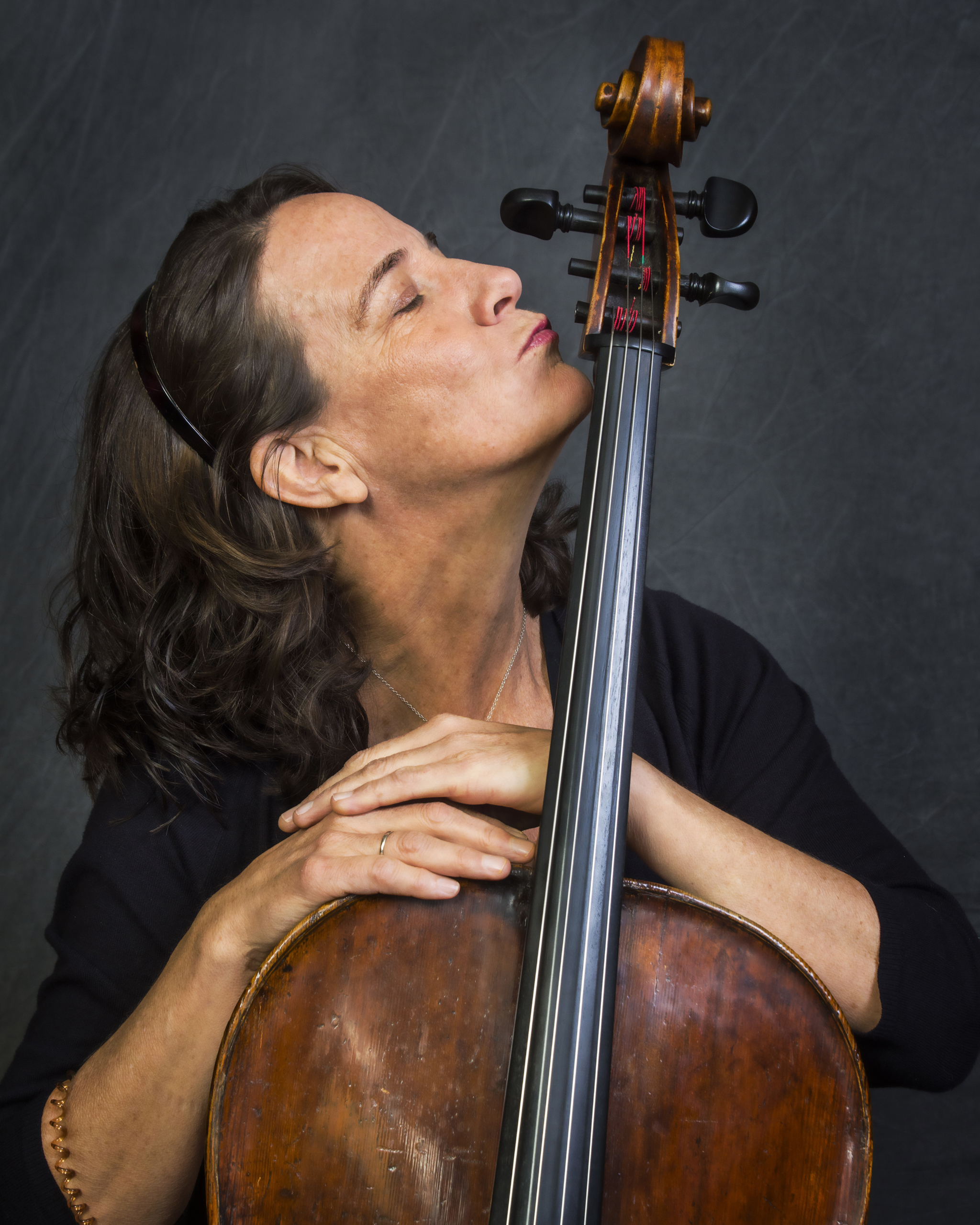 Woman kissing the neck of a cello